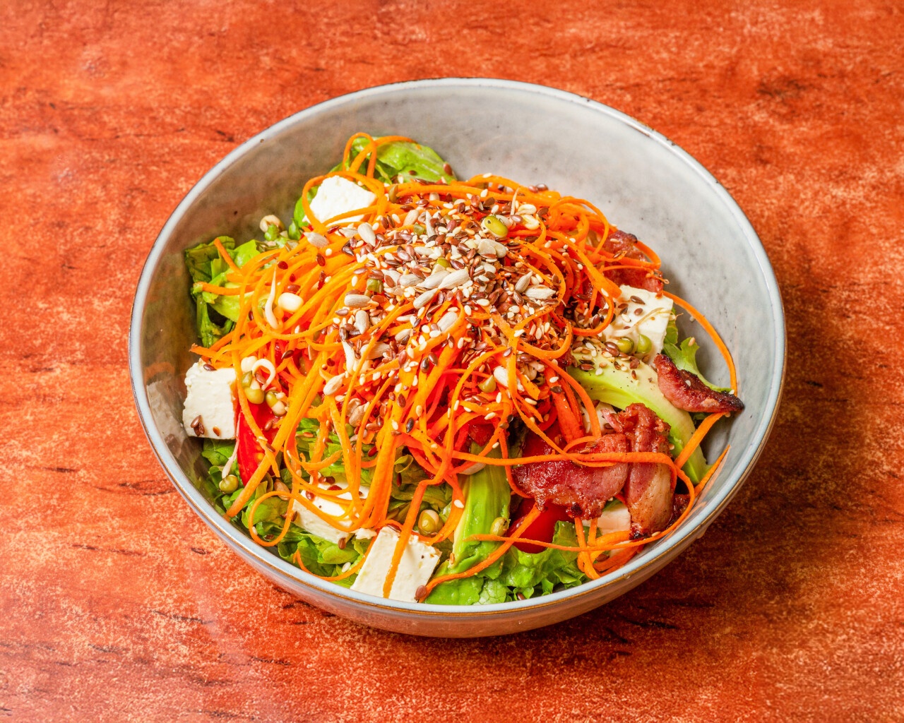 Vibrant healthy salad with mixed greens, carrots, and feta cheese