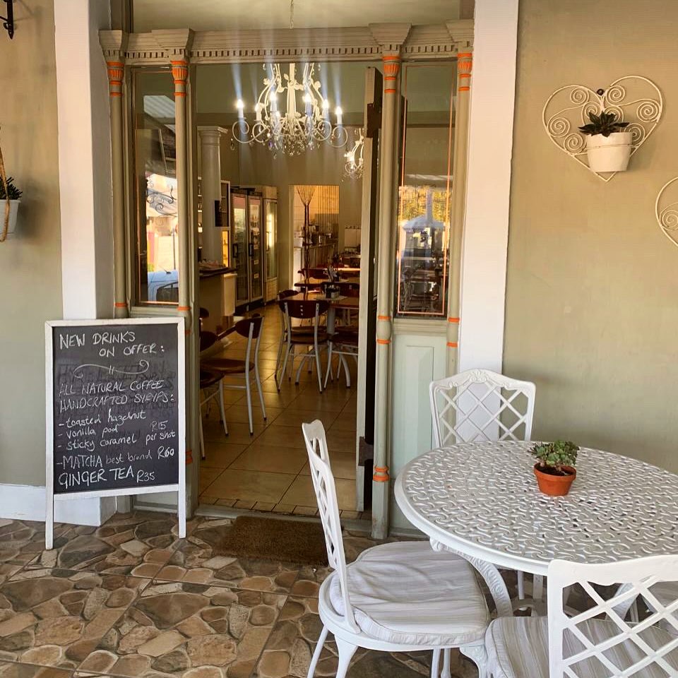 Restaurant entrance with chalkboard menu and outdoor seating