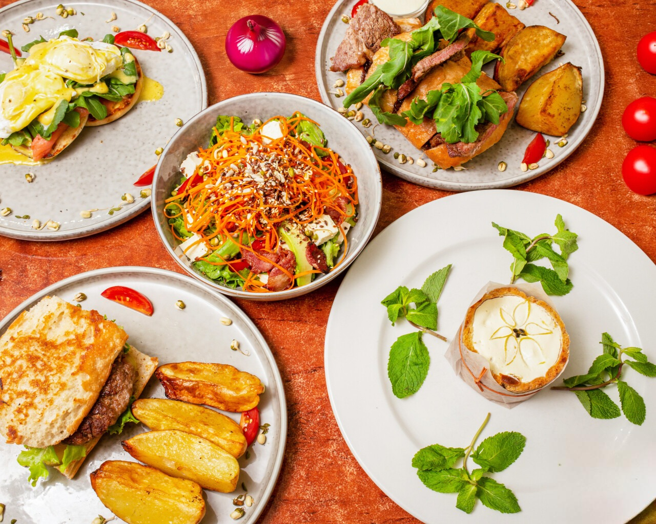Beautiful overhead view of multiple gourmet dishes and salads